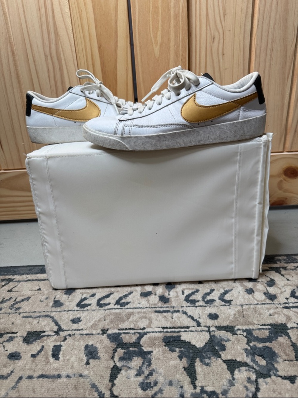 Nike White Low-Top Sneakers with Gold Swoosh